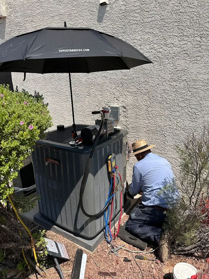 HVAC technician performing outdoor AC maintenance in Lake Geneva